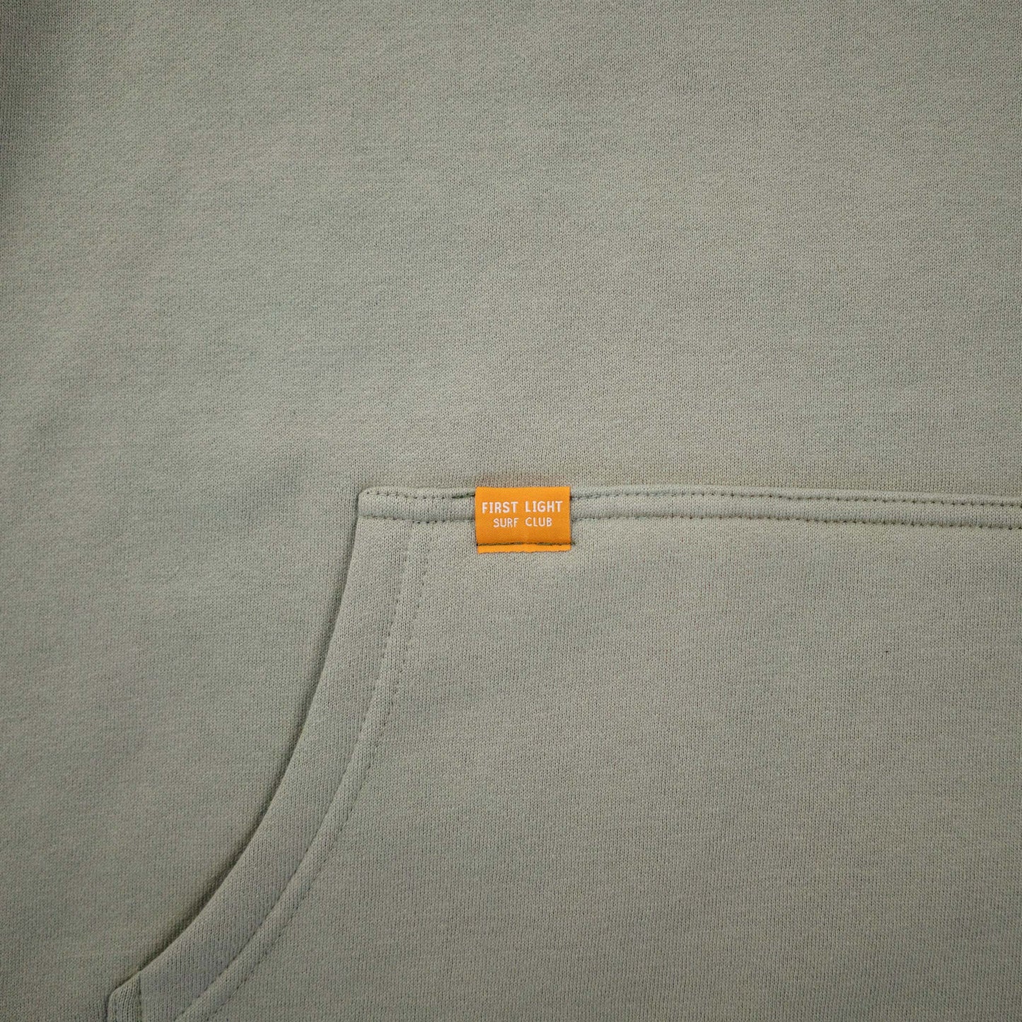 First Light Surf Club Dawn Patrol Hoodie Fleece Pistachio, Woven Label Pocket Detail